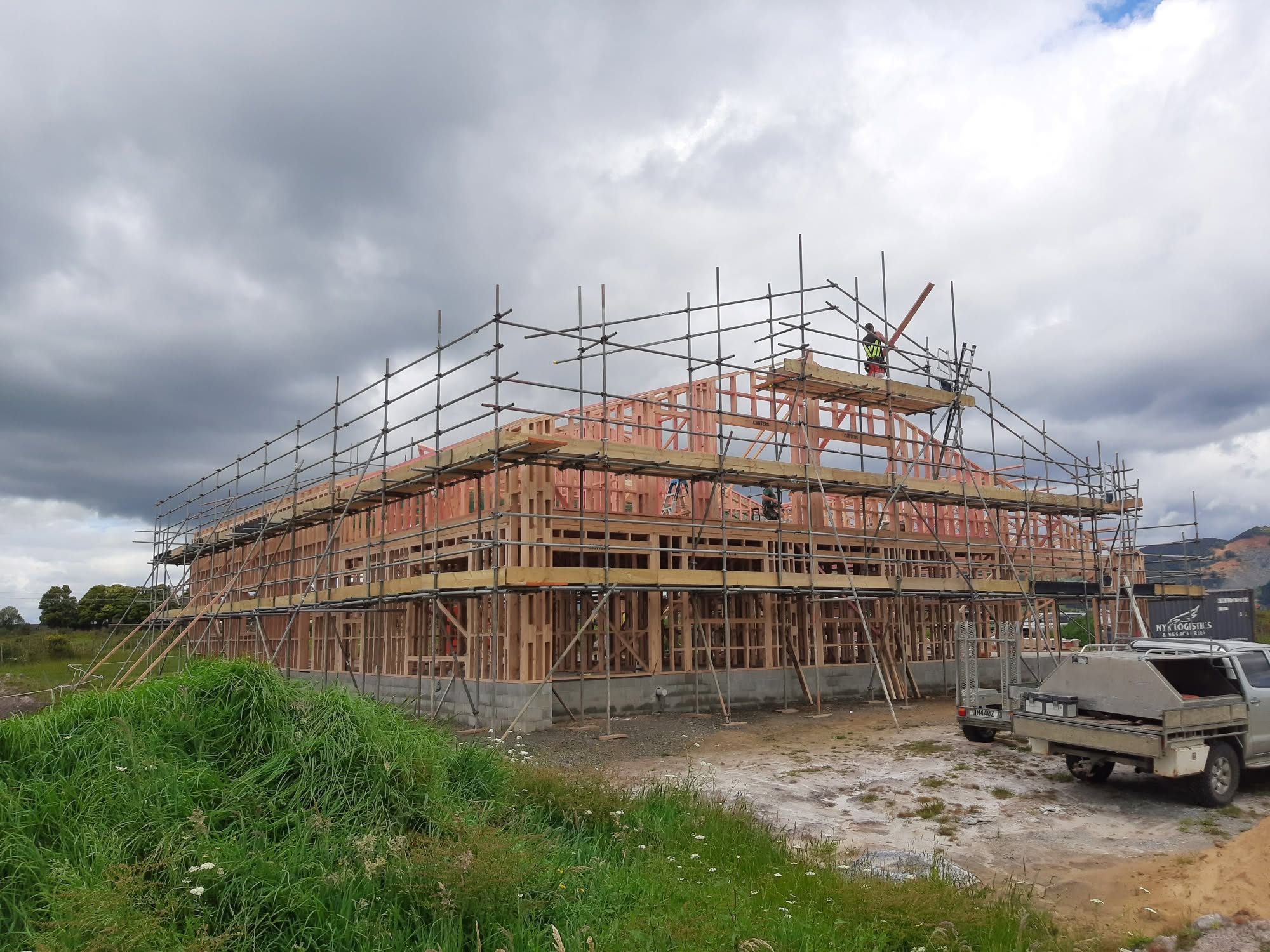 Scaffolding surrounding a timber-framed home